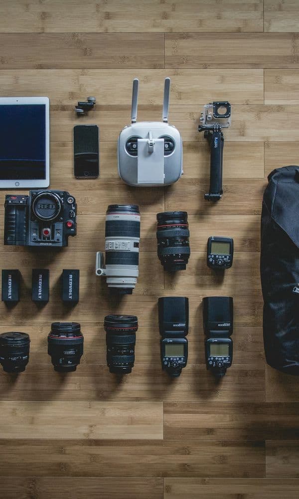 Camera bodies and lenses laid out on a wooden floor